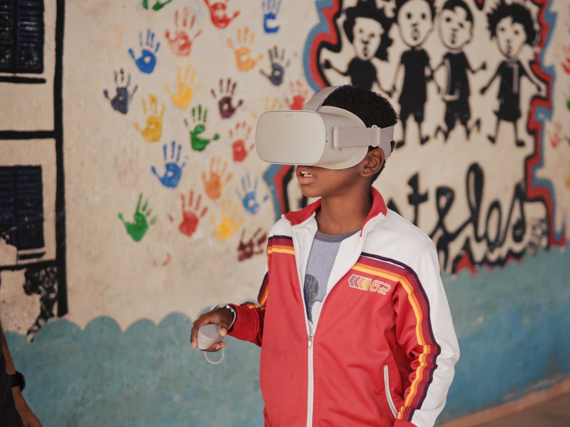 Schoolboy in Cape Verde wearing an Oculus virtual reality headset to learn about turtles
